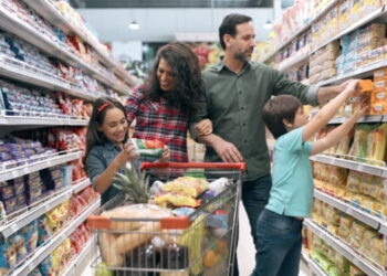 Family with two children doing the grocery shopping in supermarket