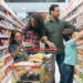 Family with two children doing the grocery shopping in supermarket